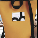 ShoppingBag im modischen Curryton. t3birds Logo in  groß auf der Vorderseite mit breitem, schwarzen Tragegurten in lang und kurz. Jetzt bei GOKAL kauf lokal